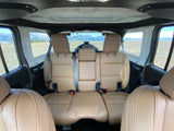 Tan interior of an off-road vehicle, looking out at mountains. Perfect for adventure trips or your next RV rental getaway.