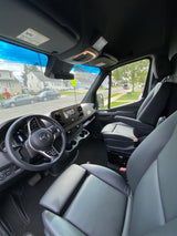 Spacious Mercedes-Benz Sprinter van interior, ideal for rv rental, showcasing the modern driver's area and street view.