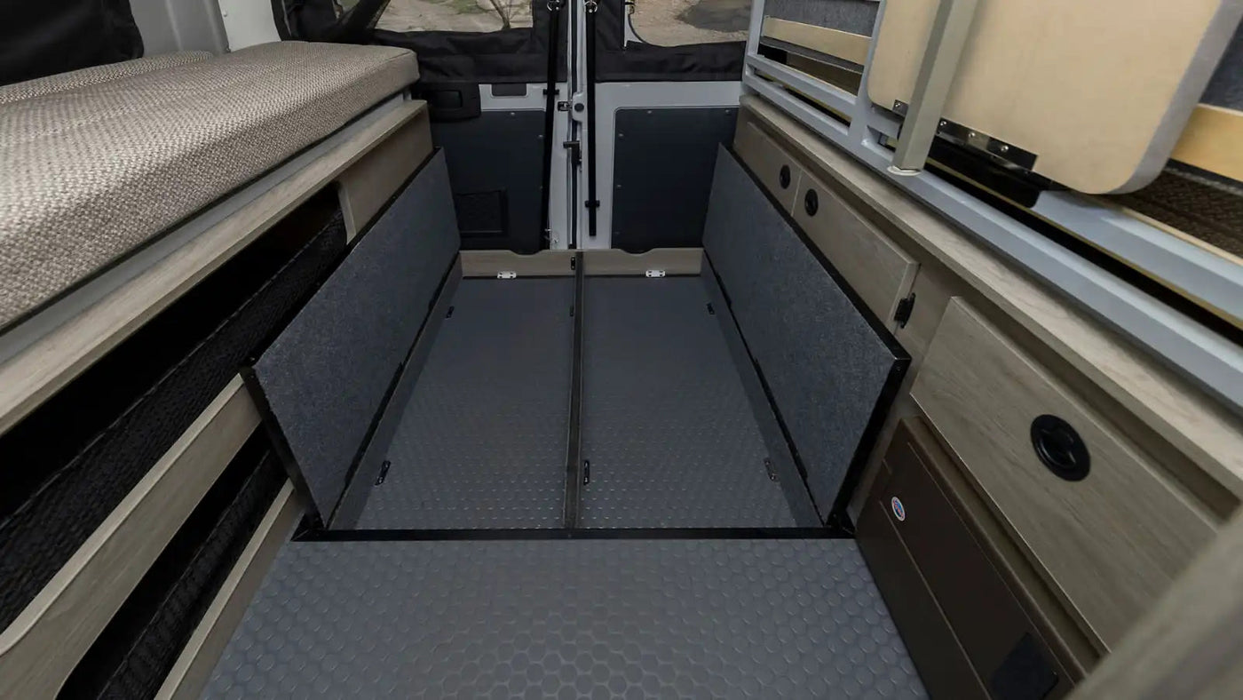  and driver's cabin view.|Cozy RV rental pop-top sleeping area with patchwork bedding — photo 16