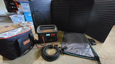 Jackery solar power setup for an RV rental trip: portable station, panels, and cooler bag. Ready for off-grid adventures.