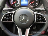 Detailed view of a Mercedes-Benz RV rental steering wheel, featuring adaptive cruise, media, and phone controls.