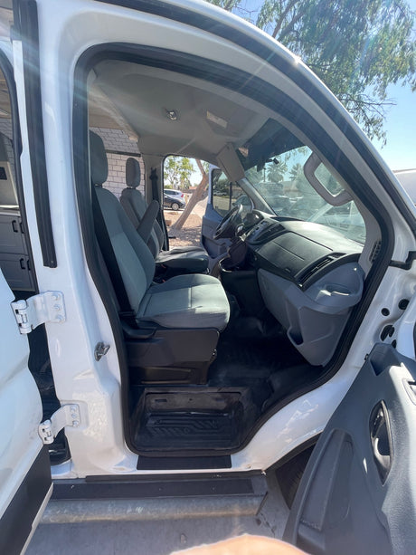 Explore the spacious interior of this converted van. Perfect for your RV rental, showing the driver's area and custom camper setup.