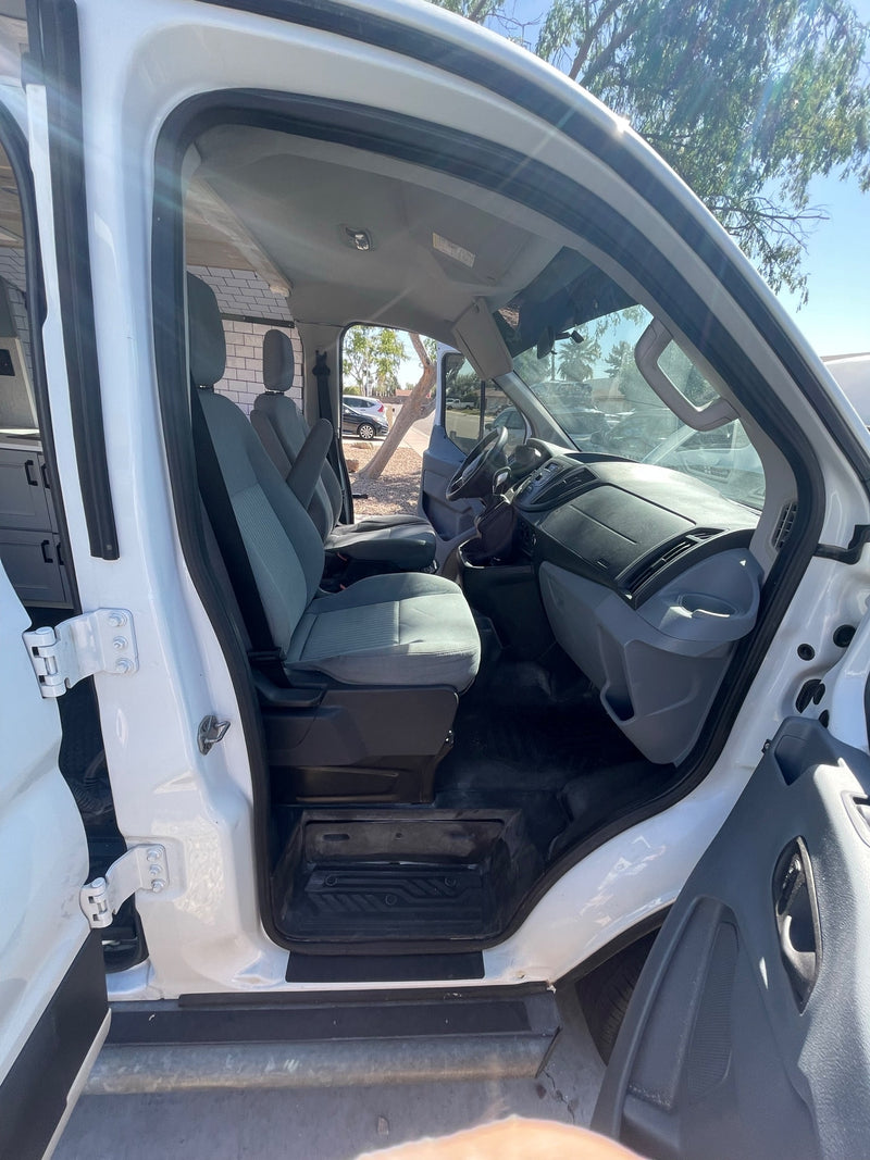Explore the spacious interior of this converted van. Perfect for your RV rental, showing the driver's area and custom camper setup. — photo 17