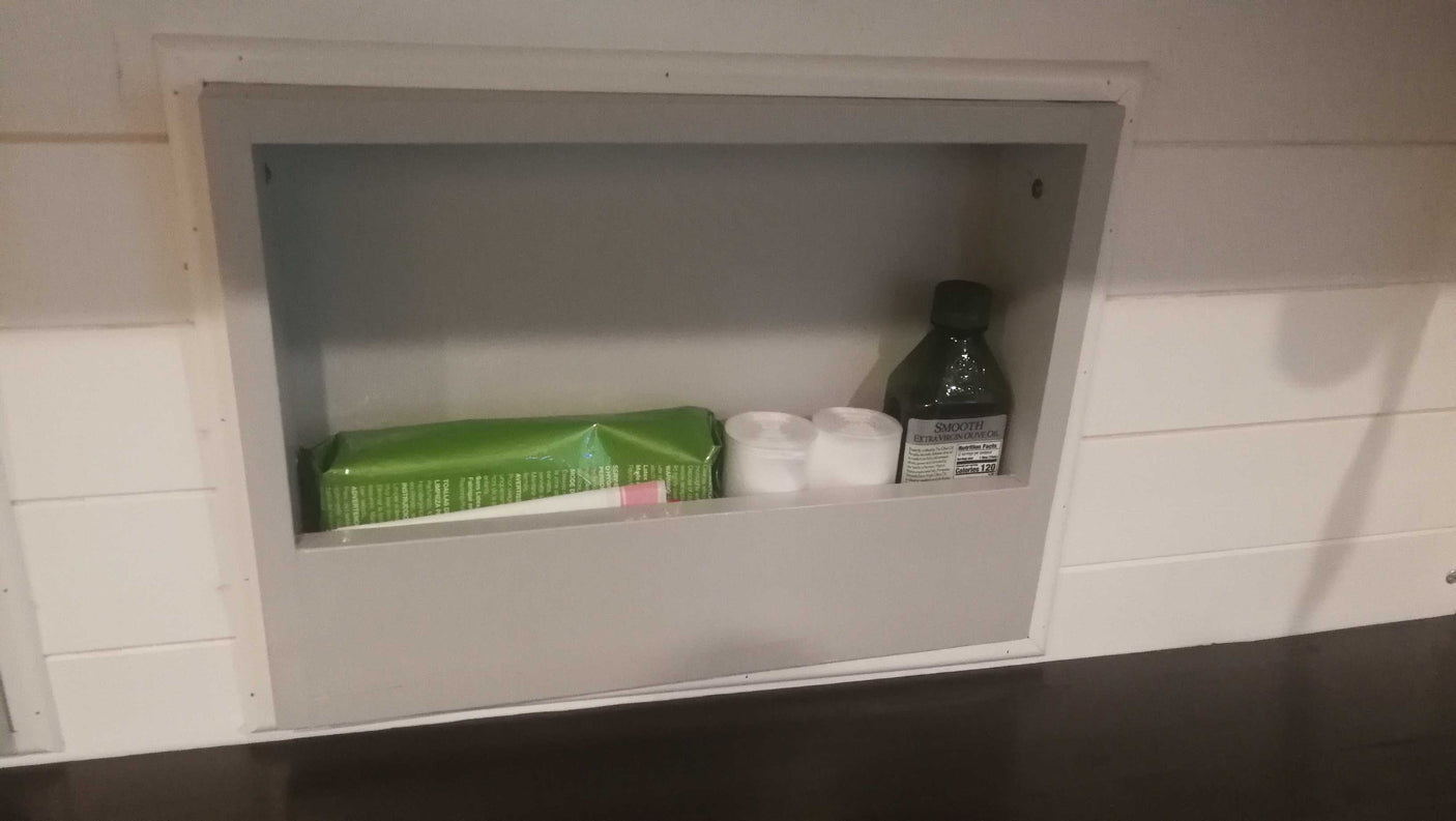 This RV rental features a practical built-in cubby with olive oil, cotton pads, and wipes for essential supplies.