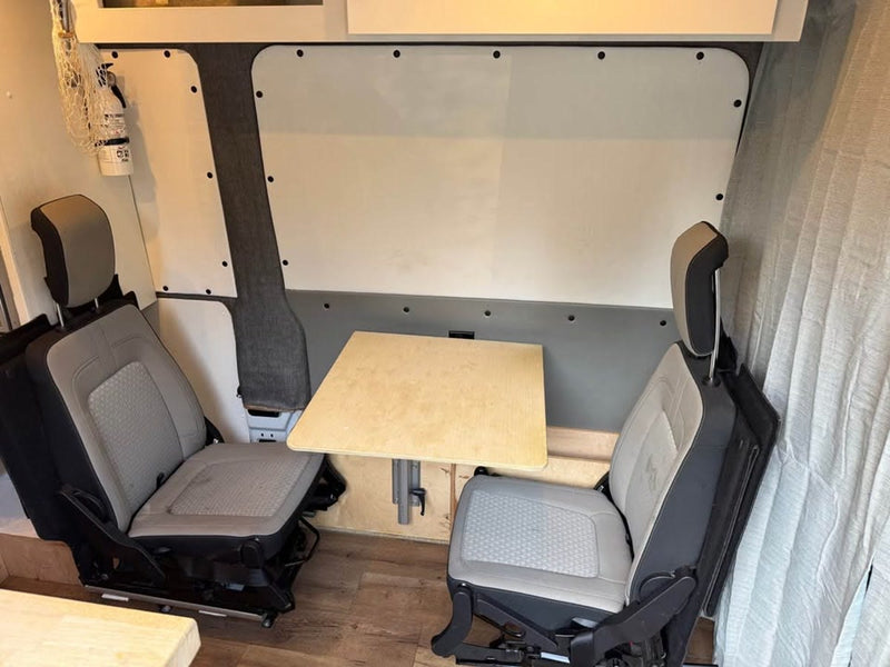  and comfortable swivel seat.|Compact RV rental interior: bed — photo 3