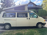 Explore the PNW! This white pop-top VW camper van, equipped with an ARB awning, is ready for your next rv rental adventure.