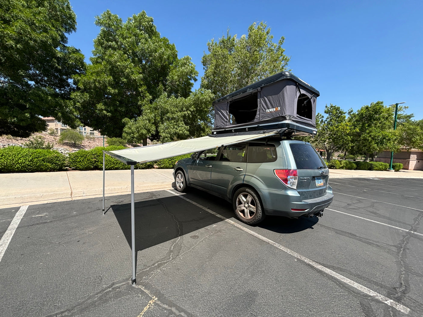 This Subaru SUV, equipped with a rooftop tent and awning, offers a unique alternative to traditional RV rentals.