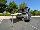 This Subaru SUV, equipped with a rooftop tent and awning, offers a unique alternative to traditional RV rentals.