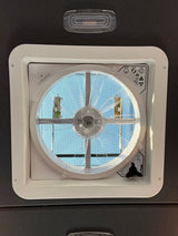 RV rental ceiling fan/vent with screen & controls (on/off, auto, open/close knob), showing a sunny sky.