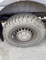Close-up of an RV rental's durable BFGoodrich All-Terrain T/A KO2 tire and Mercedes wheel, showing its robust off-road tread.