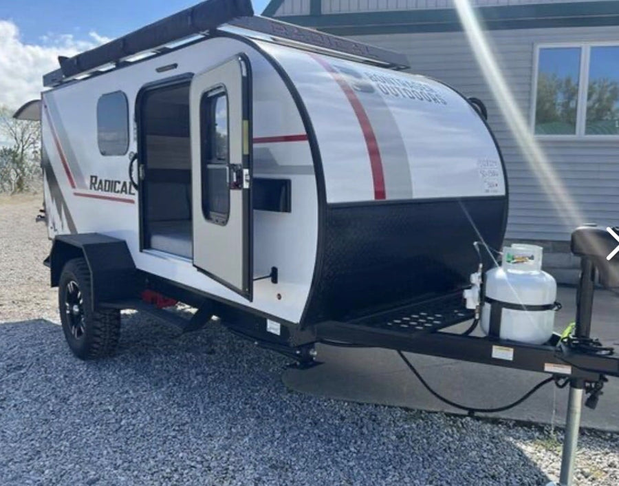  and autumn leaves. Perfect for a nature getaway.|Compact RV rental interior featuring a cozy sleeping area