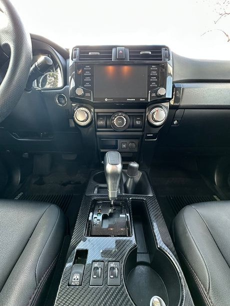 Modern SUV interior: dashboard with infotainment screen, climate controls, and gear shifter, perfect for your RV rental journey.