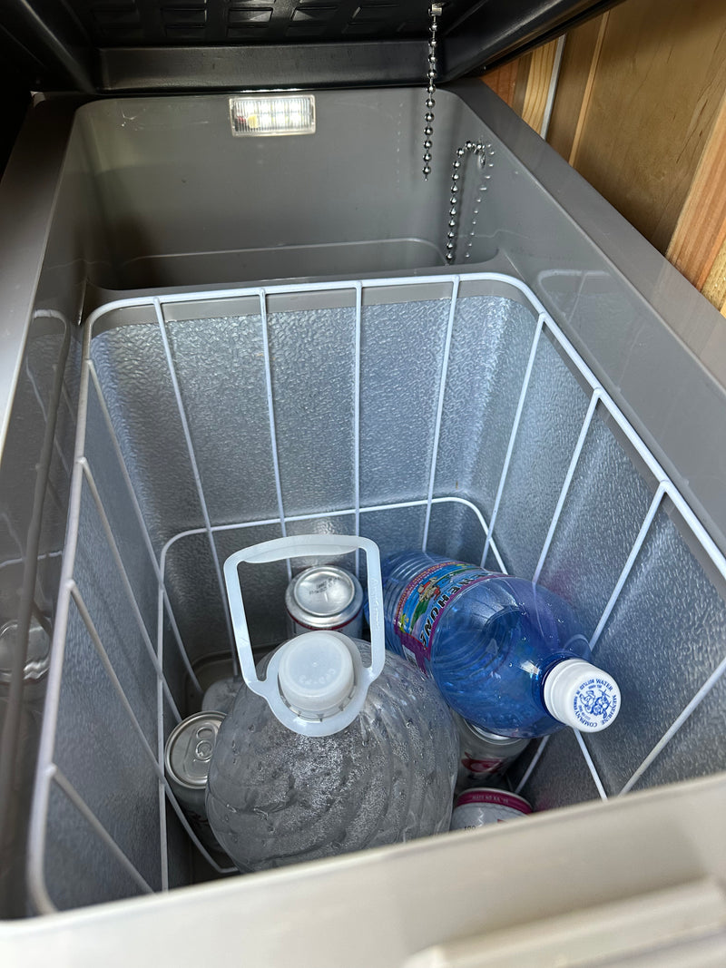 Cooler inside an RV rental, stocked with drinks: water jugs, Menehune water bottle, and cans. Essential for travel adventures. — photo 13