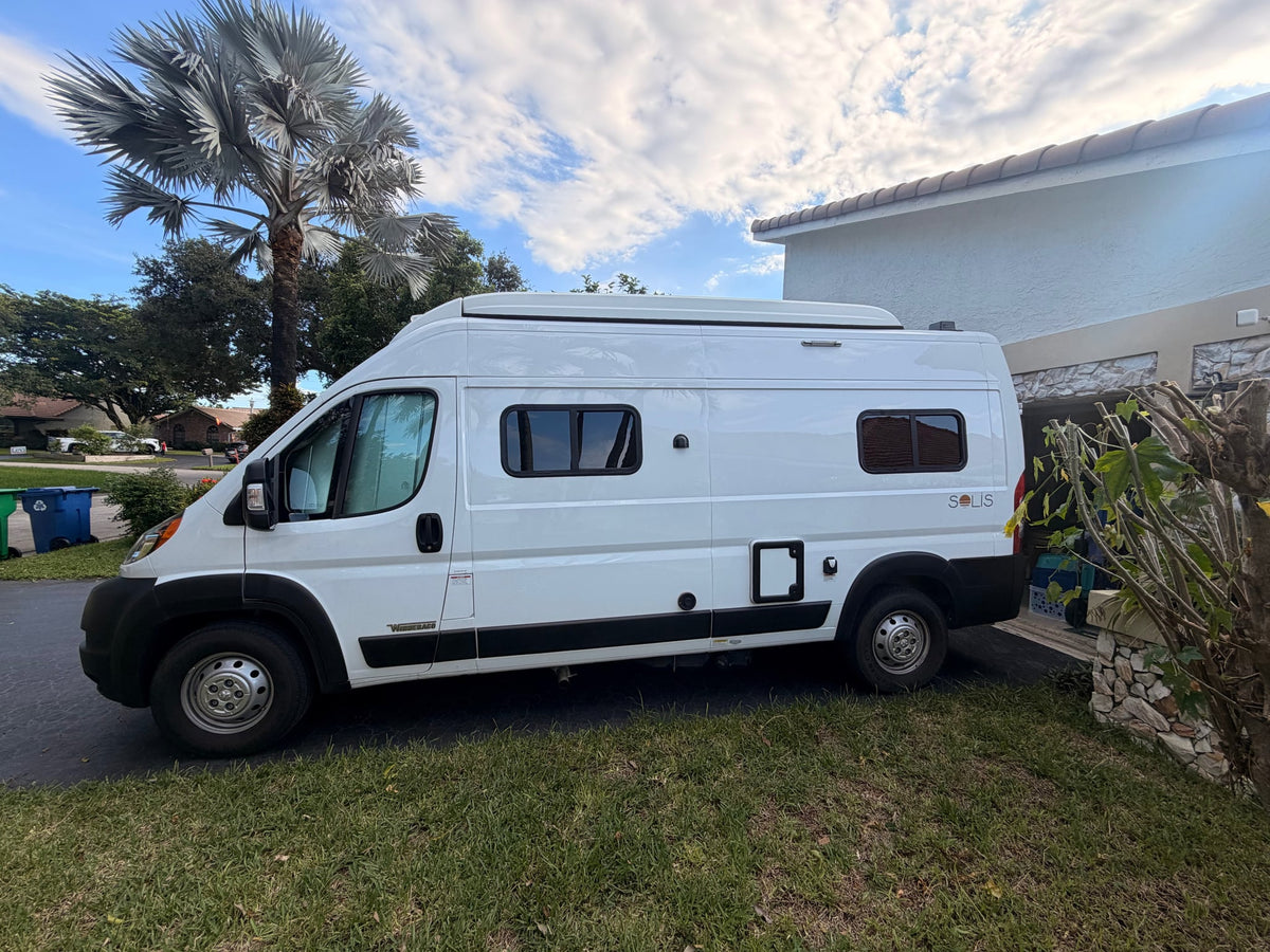  parked outside on a sunny day.|This white Winnebago Solis camper van — photo 2