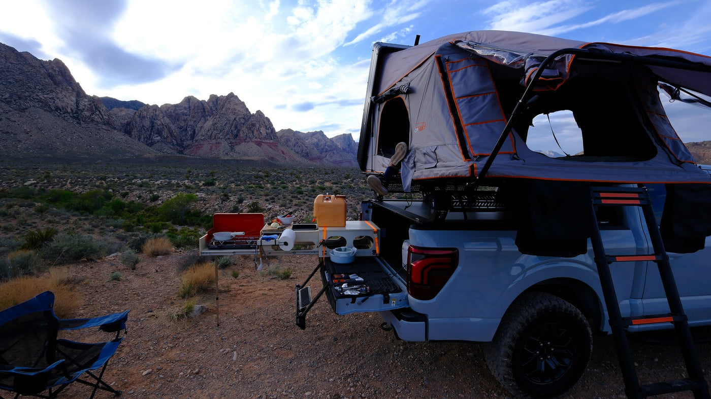 Overlanding rv rental: Pickup truck with rooftop tent & outdoor kitchen, set against stunning desert mountains. — photo 17
