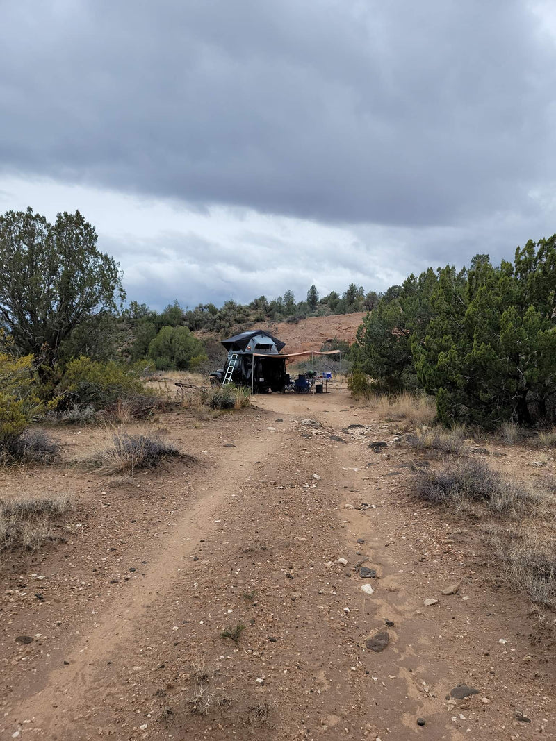  ready for off-road camping. Explore nature with this unique RV rental setup.|Black Jeep Wrangler with deployed roof-top tent & annex — photo 5