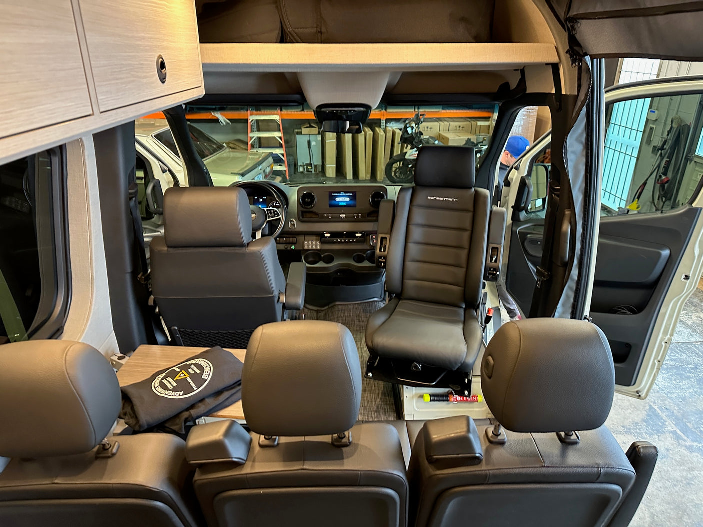 Step inside this modern RV rental! View from rear seats of the sleek cockpit, comfy Scheel-mann seats & convenient overhead storage.