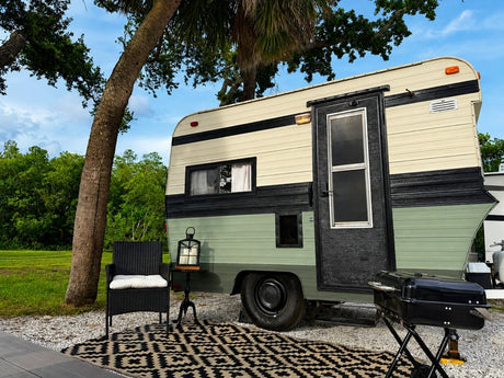 This charming RV rental features a cream and green vintage-style camper