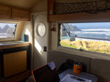 Inside a bright RV rental. Enjoy incredible ocean waves & rocky coastline from your mobile workspace. #RVlife