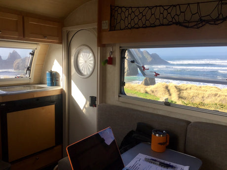 Inside a bright RV rental. Enjoy incredible ocean waves & rocky coastline from your mobile workspace. #RVlife