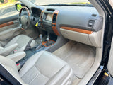 Clean Lexus GX SUV interior: wood, leather, navigation screen. Perfect for road trips, a spacious option alongside RV rental plans.