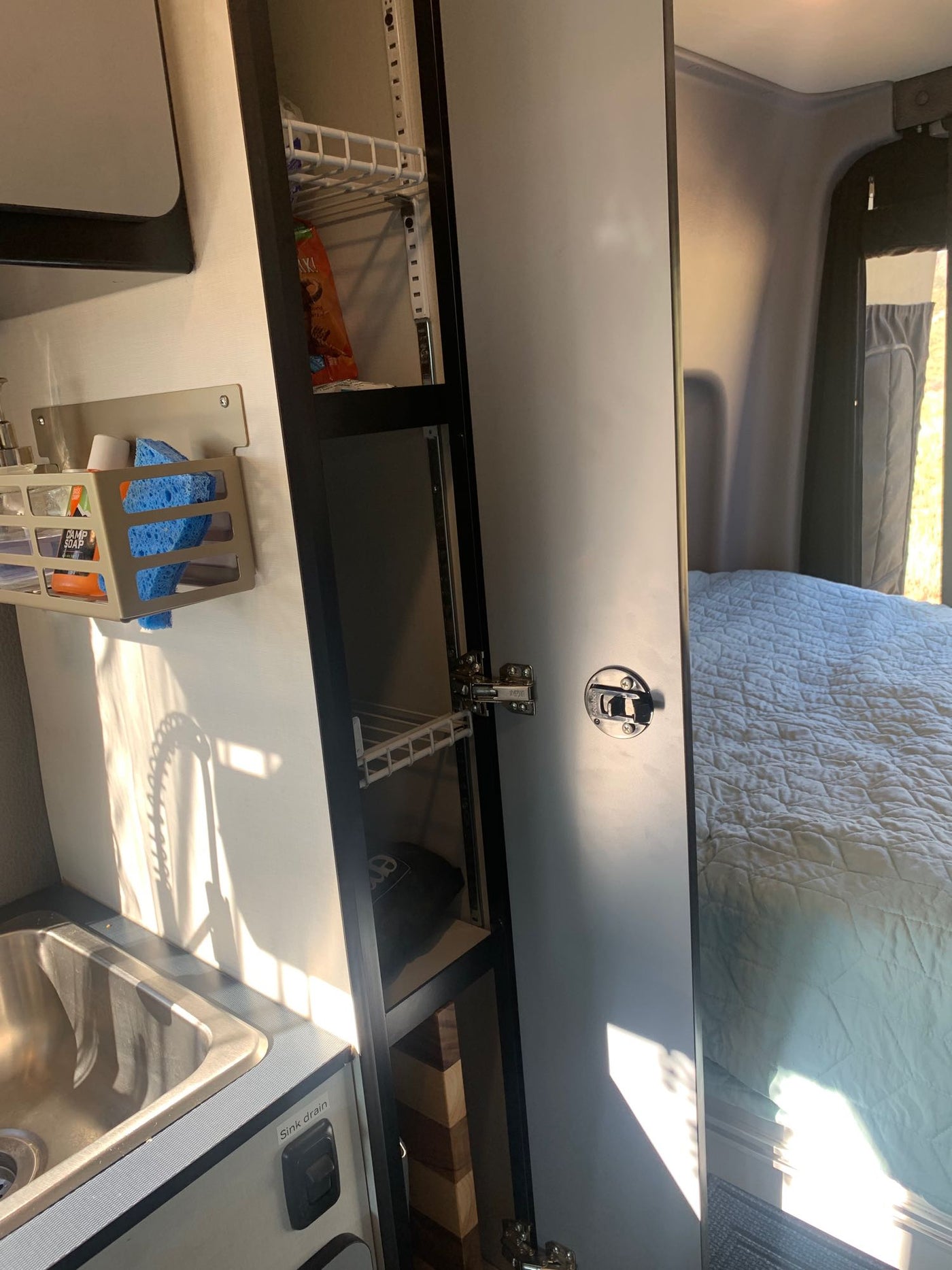  perfect alongside a red Moonlite camp chair.|Inside this Canyon Adventure RV rental: a raised bed — photo 12