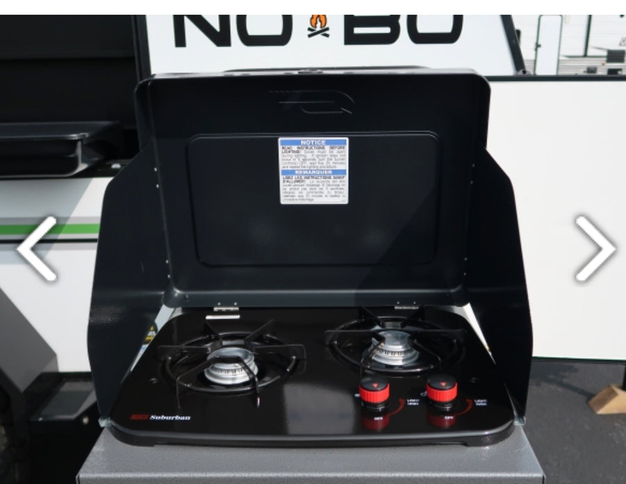 This open, black two-burner outdoor stove, ideal for an RV rental, features red control knobs and is ready for camp cooking.