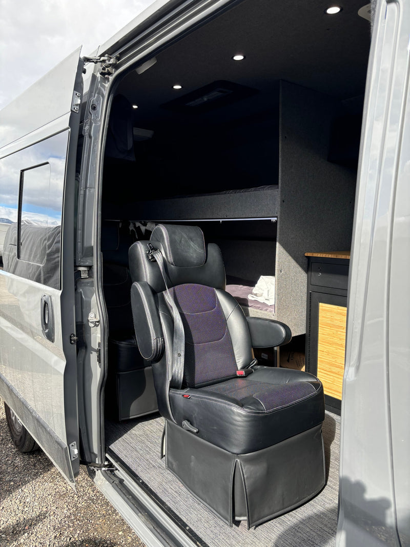 Step into comfort! This RV rental van boasts a plush seat, cozy bunk, and sleek storage, ideal for road trips. — photo 2