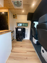 Step inside this stylish RV rental van with wood floors, shiplap walls, and versatile passenger seating.