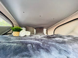  and stylish decor on white countertops.|Modern RV rental kitchen featuring open upper cabinets