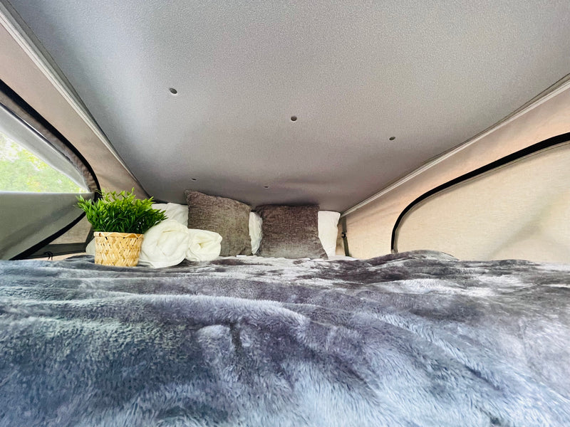  and stylish decor on white countertops.|Modern RV rental kitchen featuring open upper cabinets — photo 13