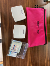 Compact Johnson & Johnson first aid supplies, including OTC meds, bandaids, gauze, and wipes, ideal for an RV rental trip.
