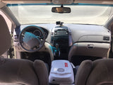 RV rental minivan interior: Toyota dash, steering wheel, and portable Igloo cooler between seats. Perfect for road trips!