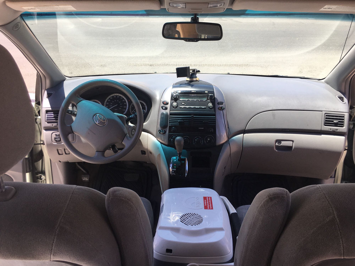  featuring a full-length mattress. Perfect for a budget-friendly RV rental alternative.|Inside an RV rental minivan: custom camper conversion with a large gray bed platform and rubber floor mat for travel.|Interior of a spacious rooftop tent for rv rental — photo 18