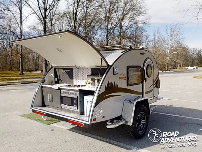 This teardrop RV rental boasts a complete outdoor kitchen, perfect for camping adventures.