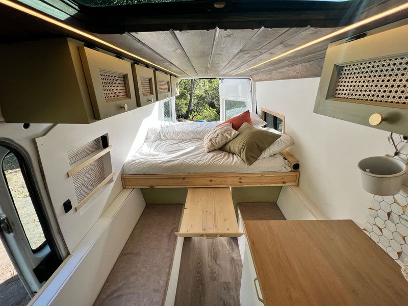  & seating.|Stylish RV rental van conversion featuring a bed — photo 6