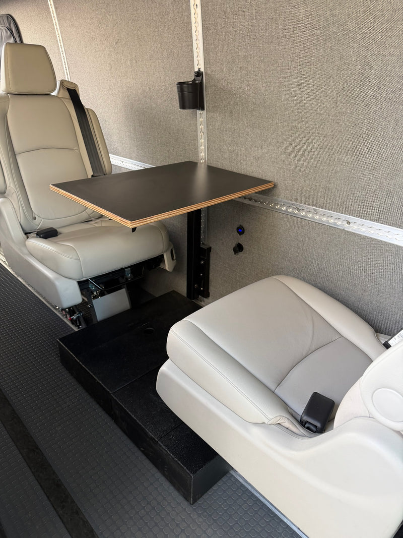 Comfortable RV rental interior with two light gray seats, a small table, and power outlets, ideal for a mobile workspace. — photo 14