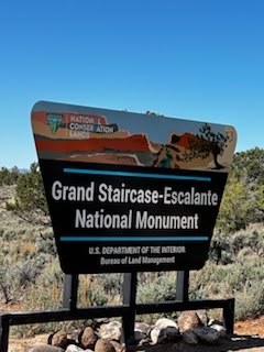A brown and black sign for Grand Staircase-Escalante National Monument, BLM managed. Great for an rv rental trip!