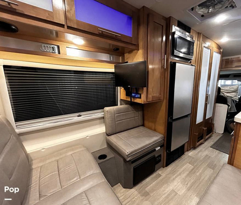 perfect for a forest camping adventure.|Inside an **rv rental**: a cozy bed with window blinds — photo 5