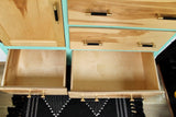 Custom wood and teal RV cabinets with open drawers & stylish brass pulls – perfect for your RV rental.