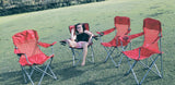 Perfect RV rental getaway! A young girl smiles in a red camp chair, with three more chairs on green grass.