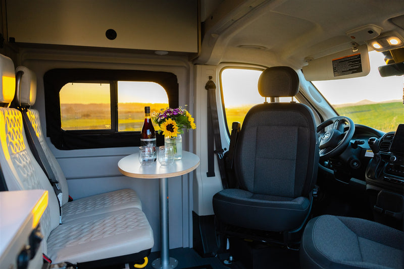  bathed in sunset light.|White pop-top RV rental parked on a dirt road at sunset. Its open side door reveals a bright — photo 13