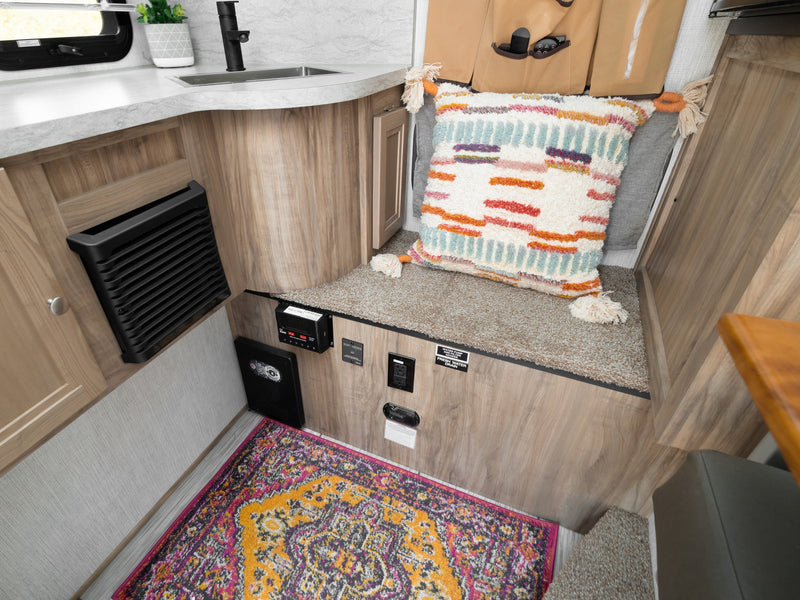 and a window view of vibrant autumn trees.|Experience comfort in this RV rental! Features a small kitchen — photo 7