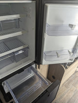 Clean, empty RV refrigerator interior in an rv rental, featuring shelves, crisper drawers, and door bins, ready for use.