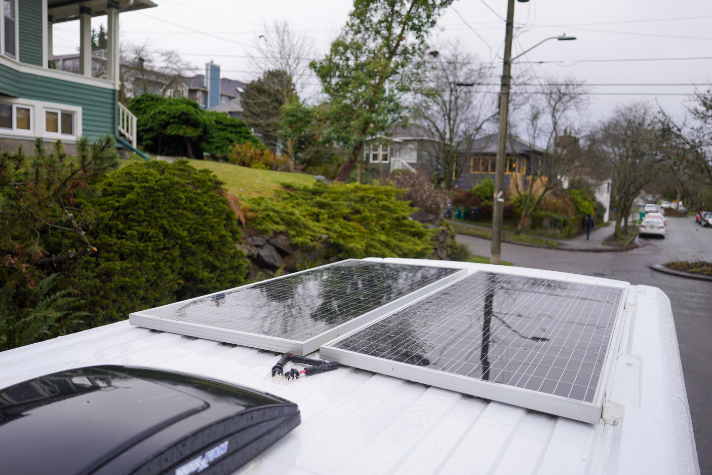 Rain-kissed solar panels on a white rv rental, providing power for off-grid adventures.