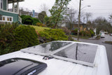 Rain-kissed solar panels on a white rv rental, providing power for off-grid adventures.