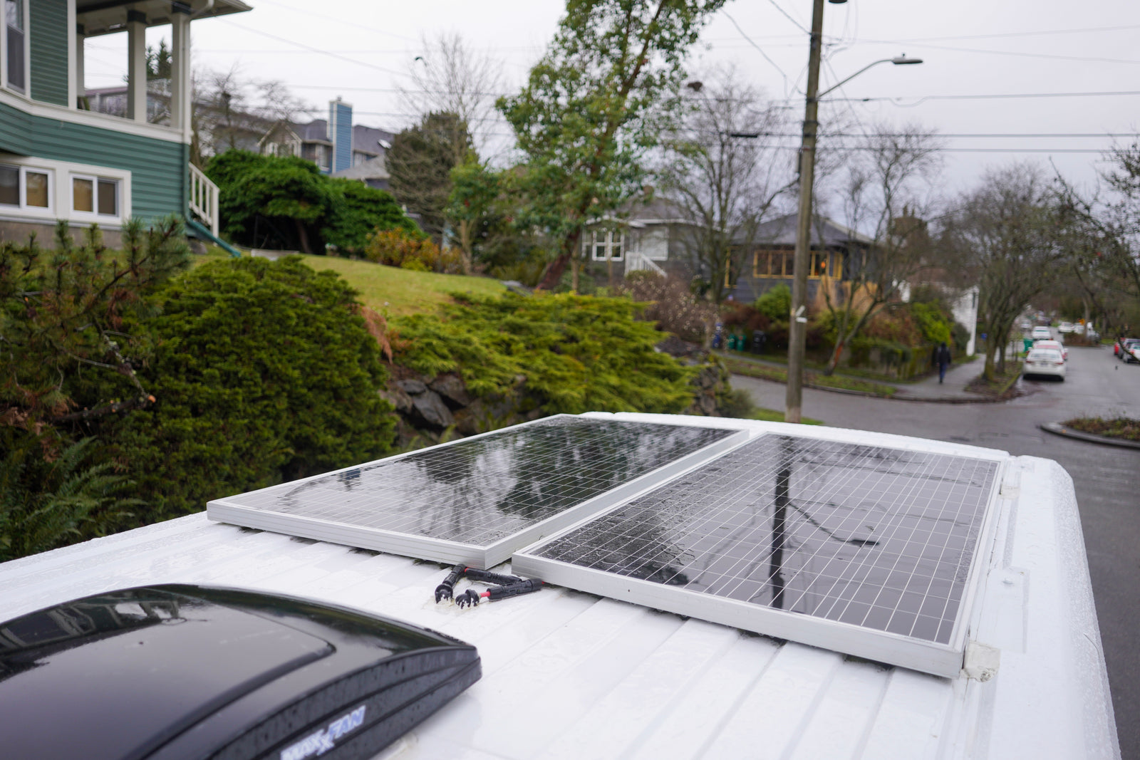 Rain-kissed solar panels on a white rv rental, providing power for off-grid adventures.