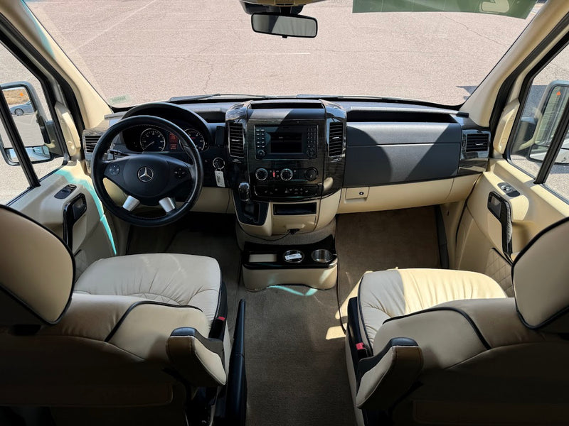 Spacious Mercedes-Benz RV rental cockpit features cream seats, sleek dashboard, and ample legroom. — photo 7