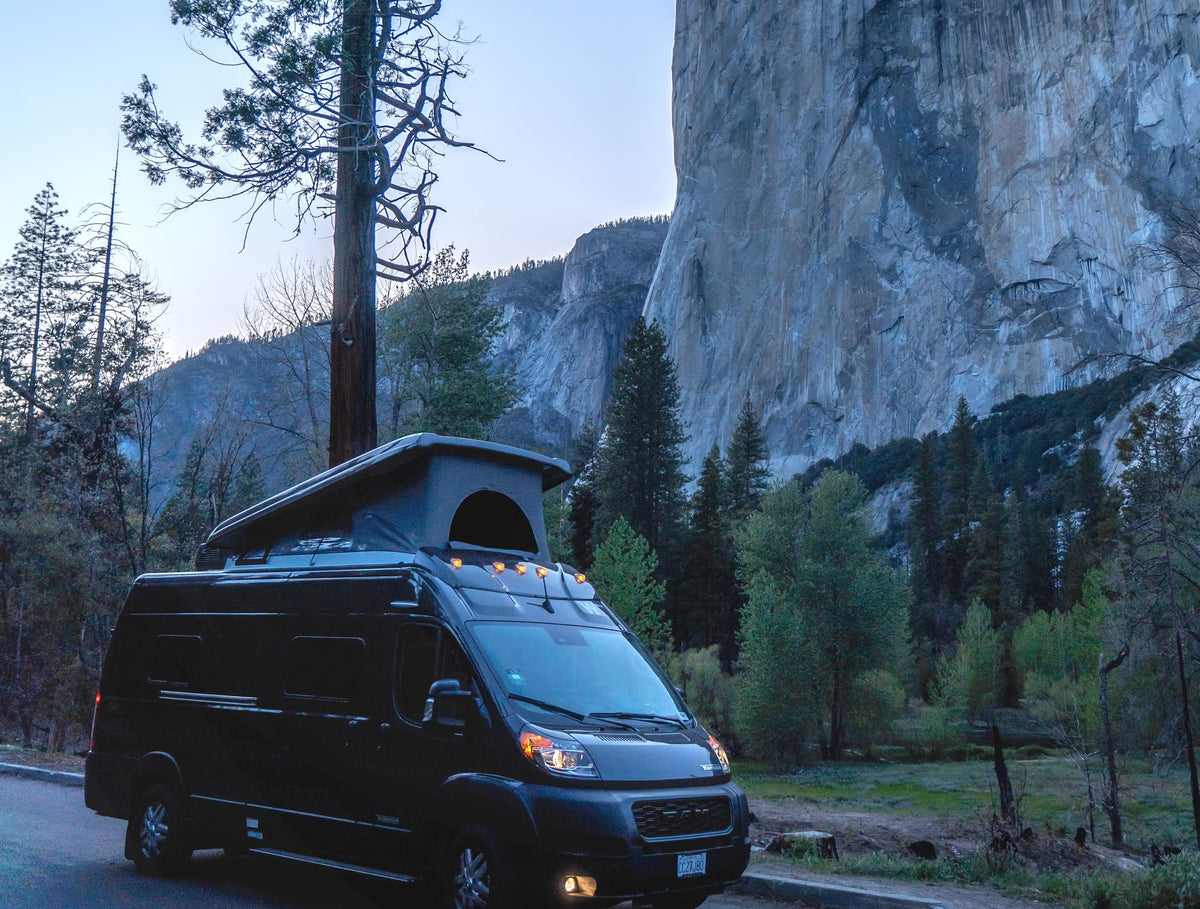 RV rental van with pop-top under El Capitan at dusk in Yosemite National Park, ready for adventure. — photo 6