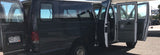A large, dark Ford van, all doors open, revealing its interior and Colorado license plate, ready for an RV rental trip.